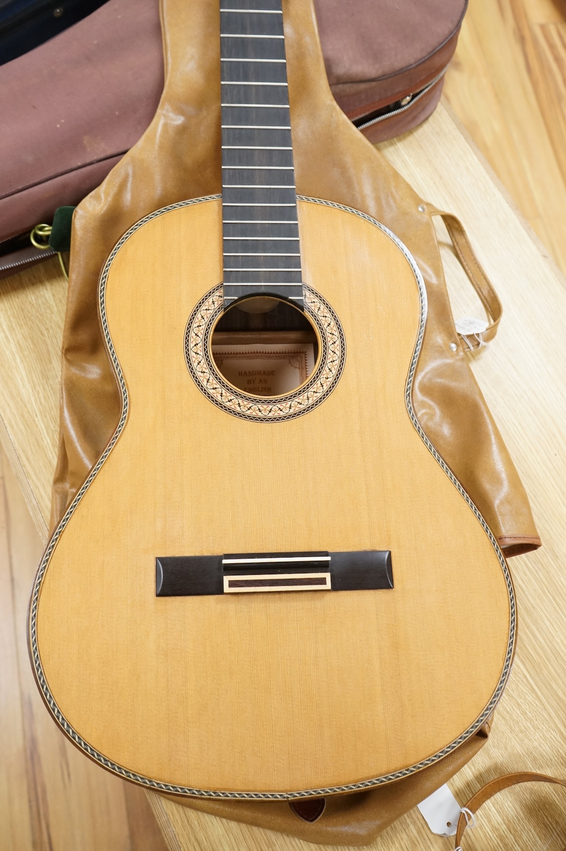 A handmade cedar, Indian Rosewood and ebony classical guitar by 'an English Luthier', with label to the inside of the body, together with a soft case.